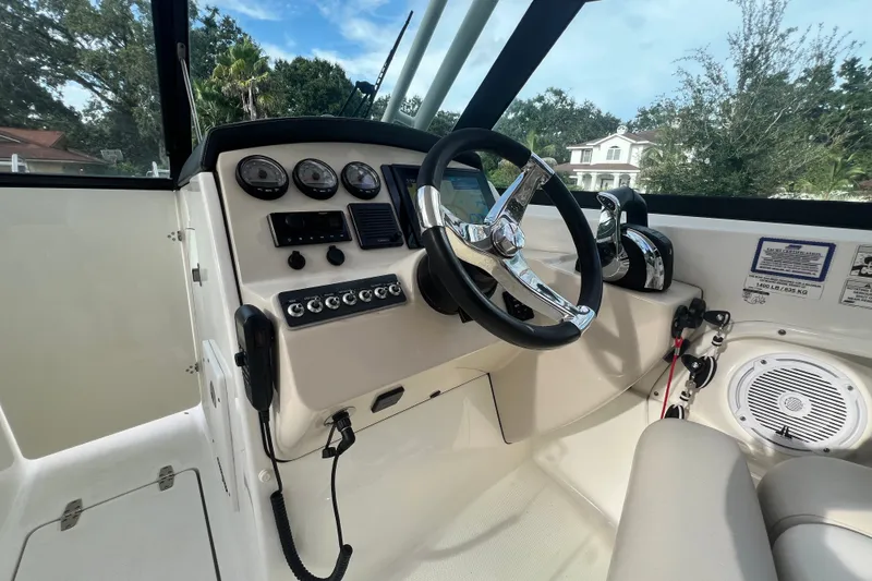 Slide: The Image of 2015 Boston Whaler 270 Vantage boat dashboard with steering wheel and control panel. - 71
