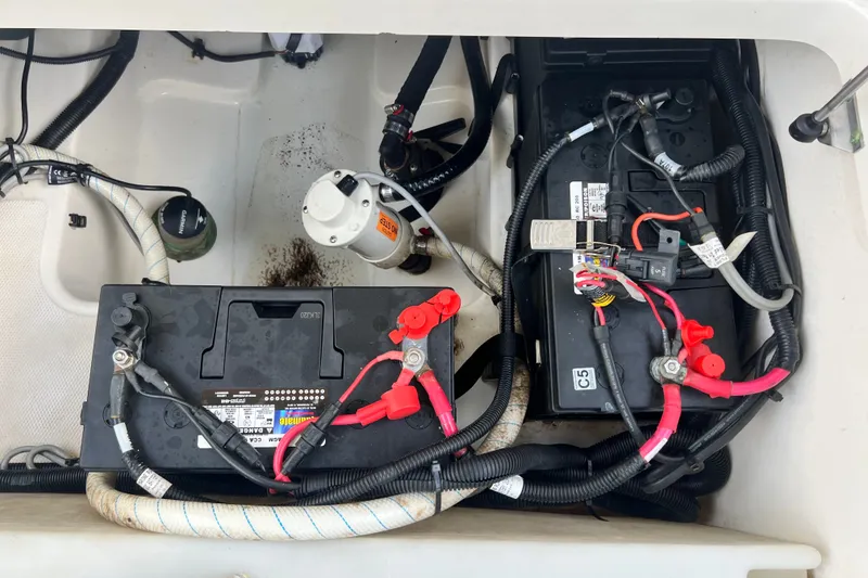 Slide: The Image of Battery compartment of a 2015 Boston Whaler 270 Vantage boat, showing wiring and connections. - 93