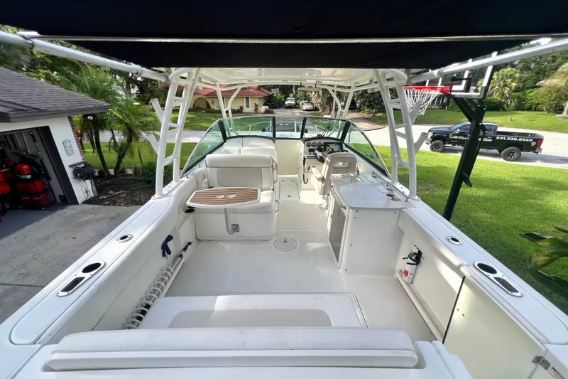 Slide: The Image of 2015 Boston Whaler 270 Vantage boat interior with seating and helm, parked in driveway. - 86
