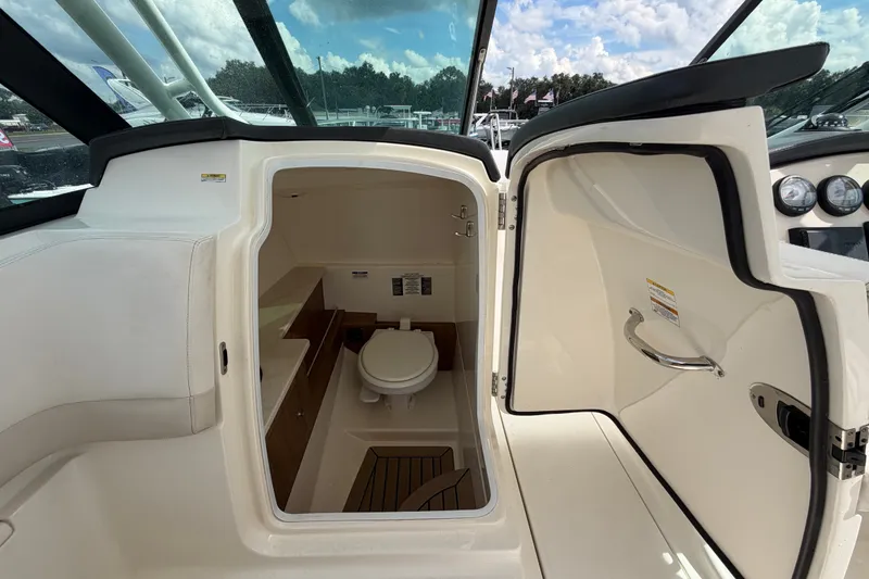 Slide: The Image of Interior view of 2015 Boston Whaler 270 Vantage boat's compact bathroom area. - 29