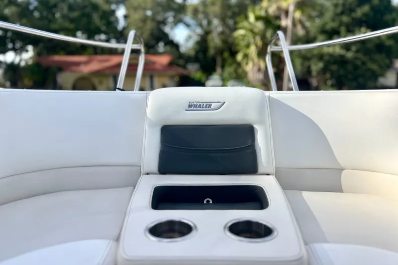 Slide: The Image of 2015 Boston Whaler 270 Vantage boat interior with cup holders and seating. - 67