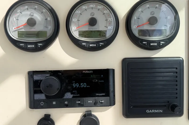 Slide: The Image of Dashboard of a 2015 Boston Whaler 270 Vantage with gauges and Garmin device. - 38