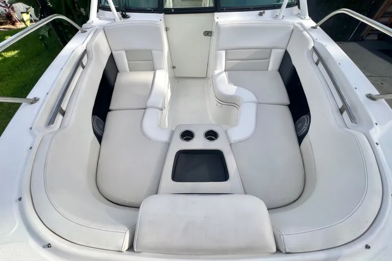 Slide: The Image of 2015 Boston Whaler 270 Vantage boat interior with white cushioned seating and cup holders. - 59