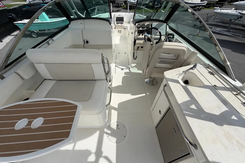 Slide: The Image of 2015 Boston Whaler 270 Vantage boat interior with seating, helm, and kitchenette. - 18