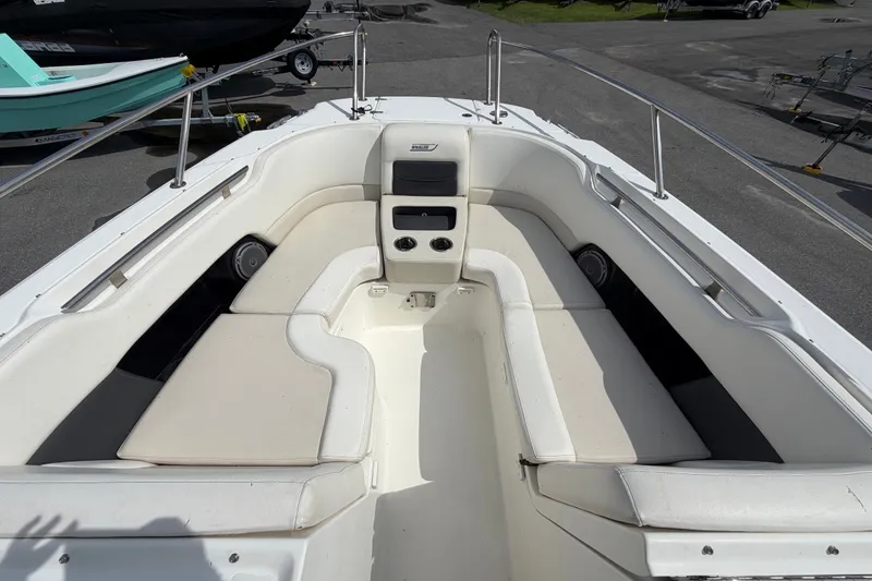 Slide: The Image of 2015 Boston Whaler 270 Vantage boat interior with cushioned seating and stainless steel railings. - 49