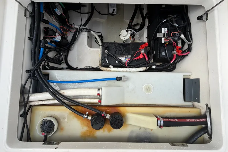 Slide: The Image of 2015 Boston Whaler 270 Vantage boat wiring and battery compartment, showcasing cables and connections. - 71