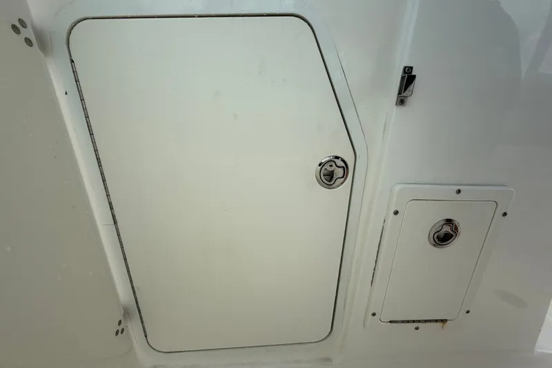 Slide: The Image of 2015 Boston Whaler 270 Vantage storage compartments with secure latches. - 45