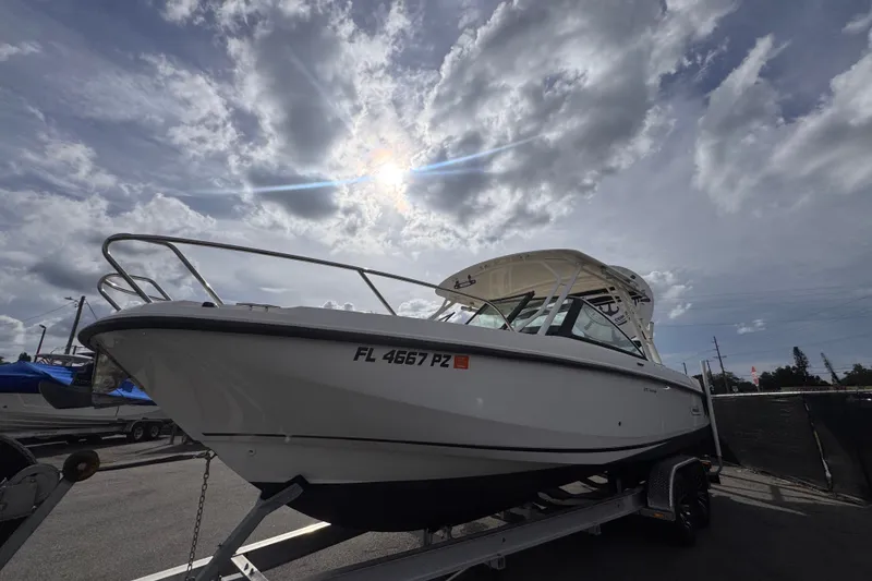 Slide: The Image of 2015 Boston Whaler 270 Vantage boat on trailer under cloudy sky. - 13