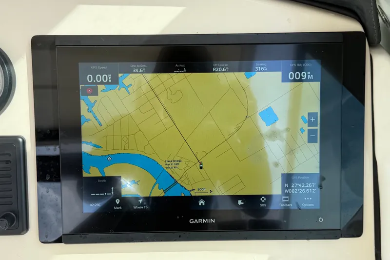 Slide: The Image of Garmin GPS display on 2015 Boston Whaler 270 Vantage boat, showing navigation map and coordinates. - 37