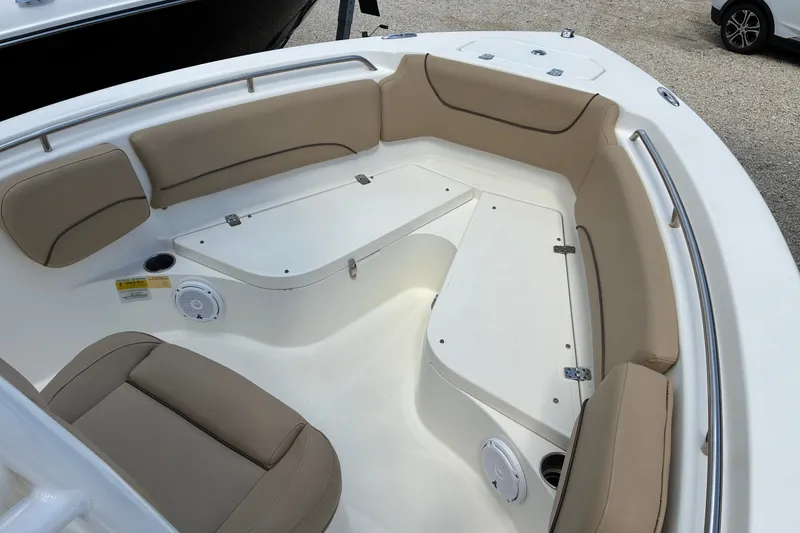 Slide: The Image of 2019 NauticStar 2102 Legacy boat interior with beige seating and storage compartments. - 8