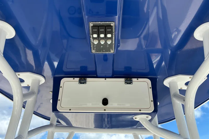 Slide: The Image of 2019 NauticStar 2102 Legacy boat console with blue canopy and control panel. - 5