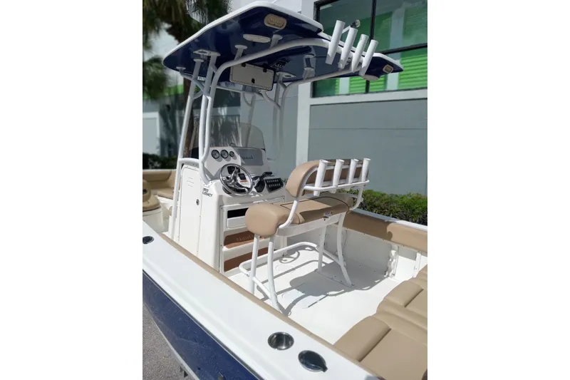 Slide: The Image of 2019 NauticStar 2102 Legacy boat interior with helm, seating, and rod holders. - 13