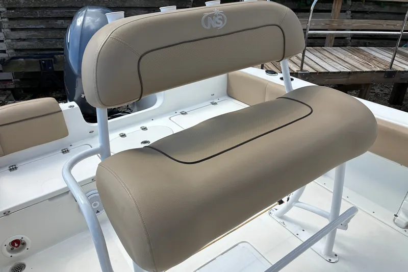 Slide: The Image of 2019 NauticStar 2102 Legacy boat seat with beige upholstery and white frame. - 6