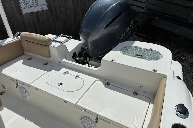 Slide: The Image of 2019 NauticStar 2102 Legacy boat with Yamaha engine, featuring spacious seating and storage compartments. - 4