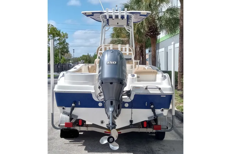 Slide: The Image of 2019 NauticStar 2102 Legacy boat with Yamaha 150 engine, parked outdoors. - 11