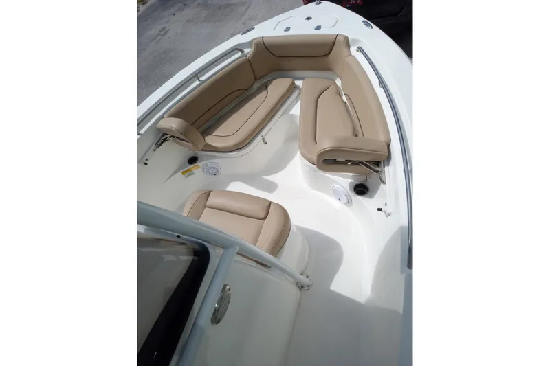 Slide: The Image of 2019 NauticStar 2102 Legacy boat interior with beige seating and white deck. - 9