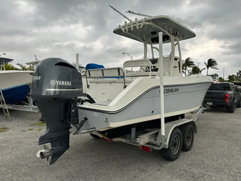Slide: The Image of 2015 Century 2301 boat with Yamaha engine on trailer, parked outdoors. - 16