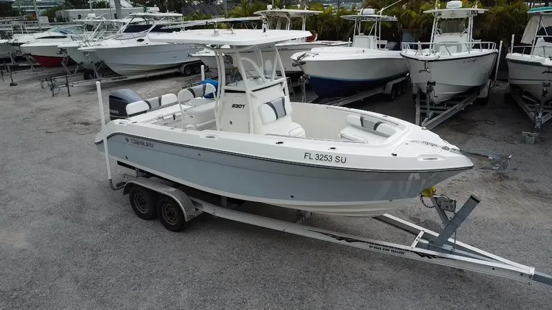 Slide: The Image of 2015 Century 2301 boat on trailer in marina, surrounded by other boats. - 0