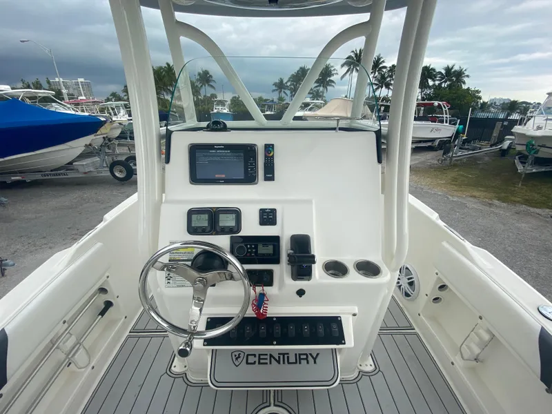 Slide: The Image of Century 2301 boat dashboard, 2015 model, featuring steering wheel and navigation controls. - 25