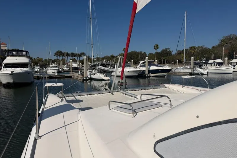 Slide: The Image of Leopard 38 catamaran docked in a marina, surrounded by various boats. - 134