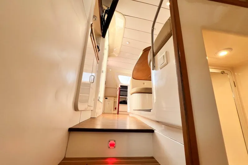 Slide: The Image of Interior of 2000 Leopard 38 yacht, featuring wooden steps and modern design elements. - 65