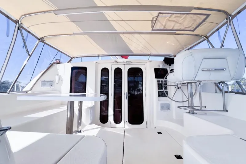 Slide: The Image of Interior view of a 2000 Leopard 38 catamaran, featuring a shaded cockpit and seating area. - 22