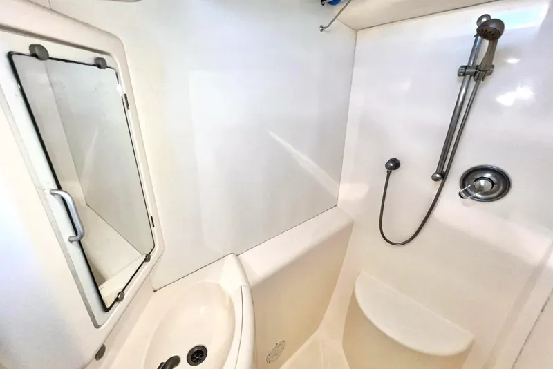 Slide: The Image of Compact bathroom in a 2000 Leopard 38 yacht with shower and sink. - 69