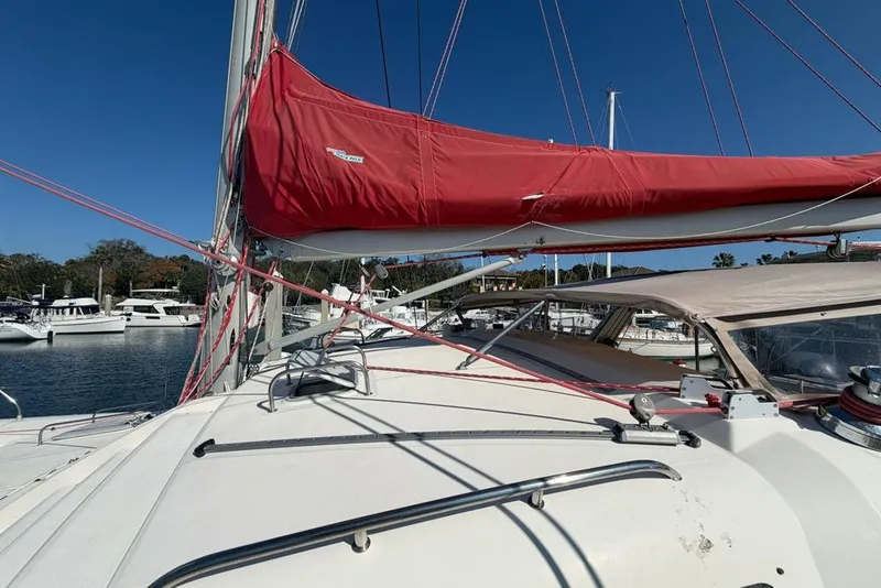 Slide: The Image of Sailing yacht Leopard 38, 2000 model, with red sail cover, docked in marina. - 135