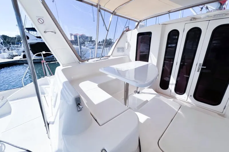 Slide: The Image of Leopard 38 yacht cockpit, 2000 model, featuring sleek seating and table, docked at marina. - 21