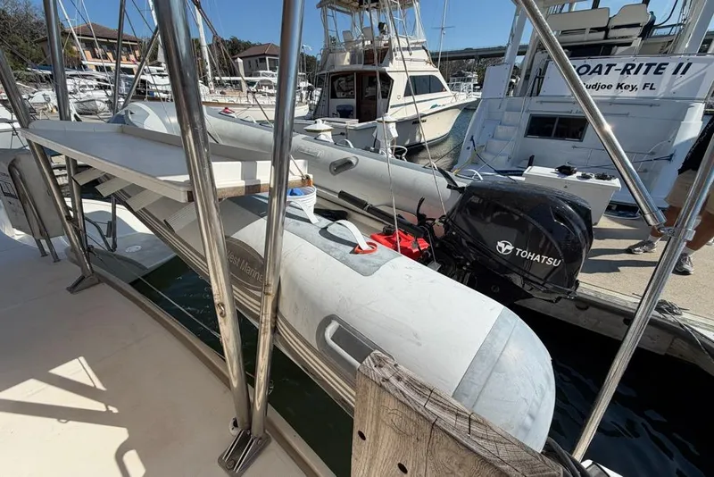 Slide: The Image of Docked Leopard 38 catamaran with Tohatsu outboard motor, 2000 model, in a marina setting. - 152