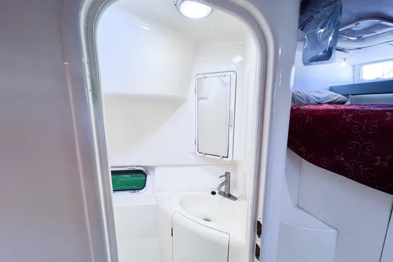 Slide: The Image of Compact bathroom in a 2000 Leopard 38 yacht, featuring a sink and mirror. - 80