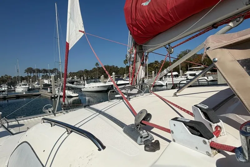 Slide: The Image of Sailboat deck view of a 2000 Leopard 38 catamaran in a marina setting. - 142