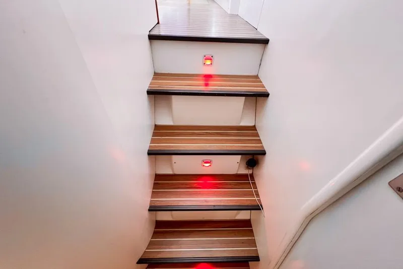 Slide: The Image of Wooden stairs with red LED lights on a Leopard 38, 2000 model yacht. - 61