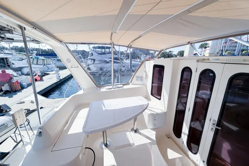 Slide: The Image of Leopard 38 catamaran cockpit with table, docked at marina, sunny day. - 30