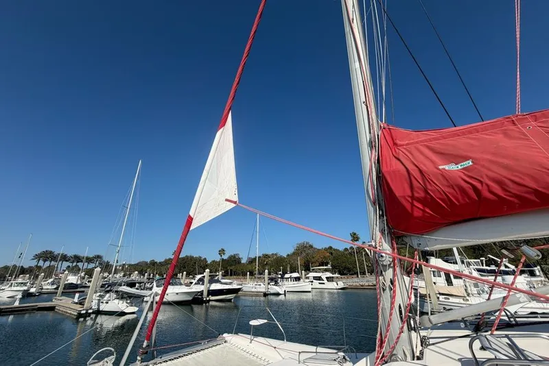 Slide: The Image of Sailboat Leopard 38, 2000 model, docked in marina under clear blue sky. - 138