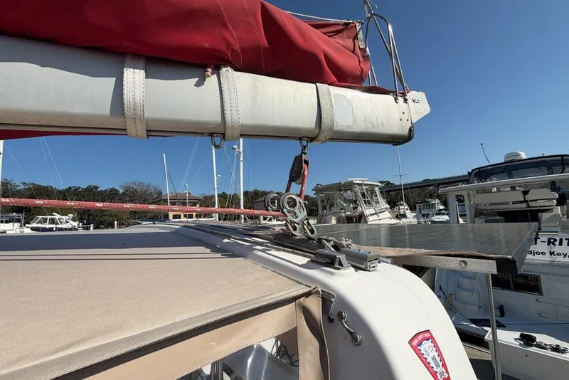 Slide: The Image of Sailboat Leopard 38, 2000 model, docked with red sail cover and clear blue sky. - 144