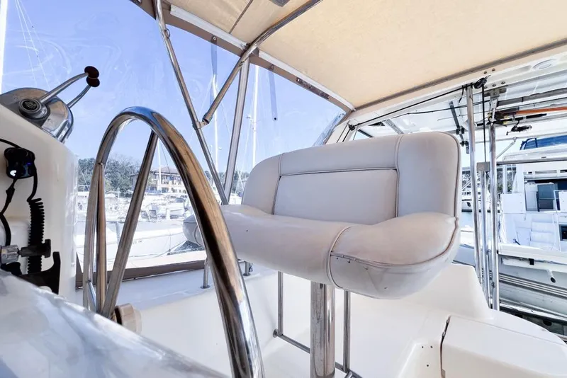 Slide: The Image of Helm station of 2000 Leopard 38 catamaran with steering wheel and cushioned seat. - 25