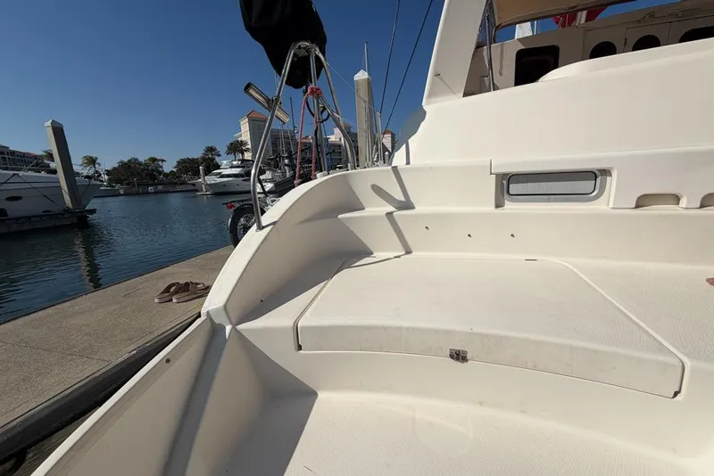 Slide: The Image of Leopard 38 catamaran docked at marina, showcasing spacious deck area, 2000 model. - 149