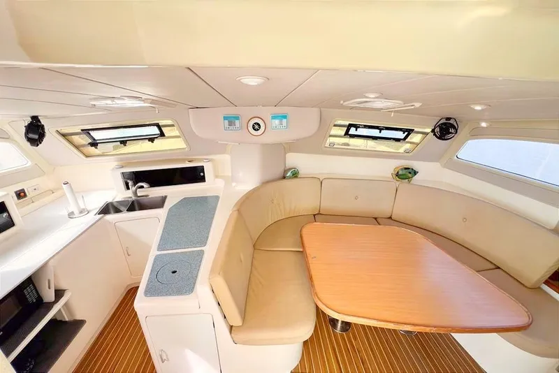Slide: The Image of Interior of 2000 Leopard 38 catamaran with kitchen and seating area. - 34