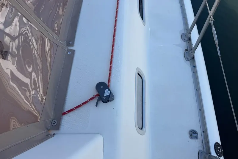 Slide: The Image of Deck of a 2000 Leopard 38 catamaran with red rope and railing. - 97