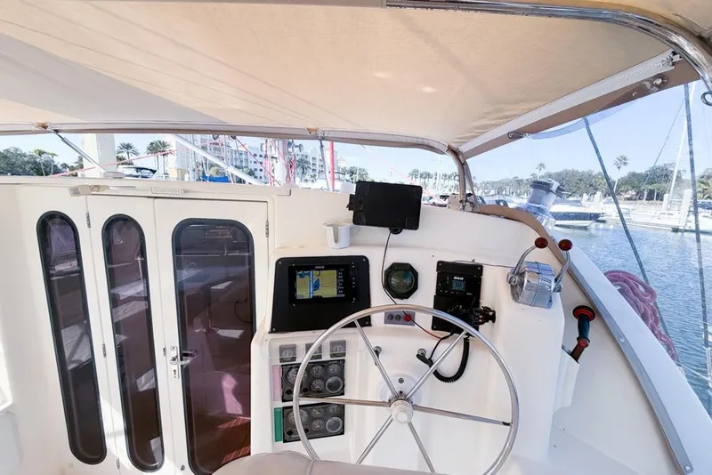 Slide: The Image of Helm of 2000 Leopard 38 catamaran with navigation equipment and steering wheel. - 27