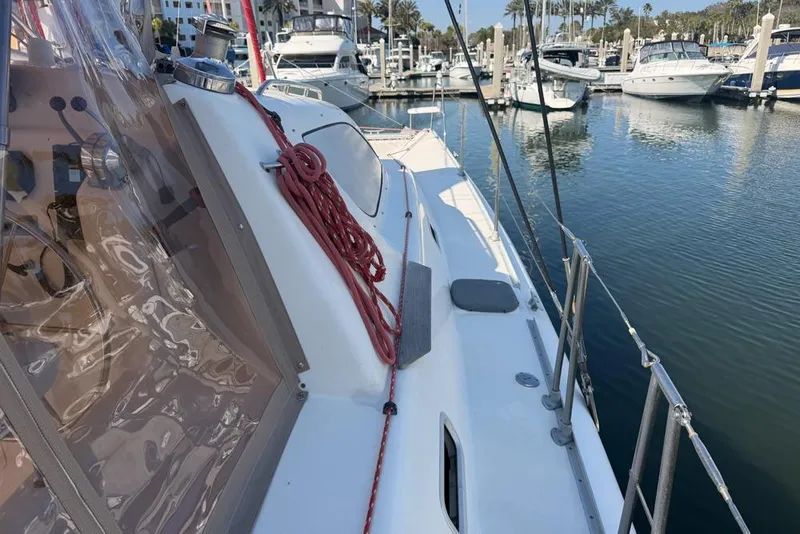 Slide: The Image of Leopard 38 catamaran docked in marina, showcasing deck and rigging, 2000 model. - 98