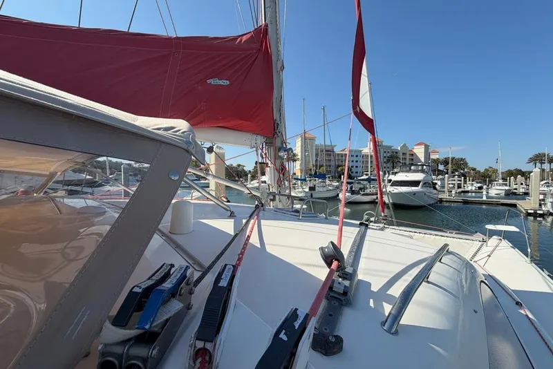 Slide: The Image of Sailboat Leopard 38, 2000 model, docked in marina with red sails and clear blue sky. - 101