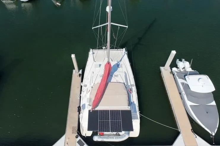 Slide: The Image of Aerial view of a 2000 Leopard 38 catamaran docked at a marina. - 17