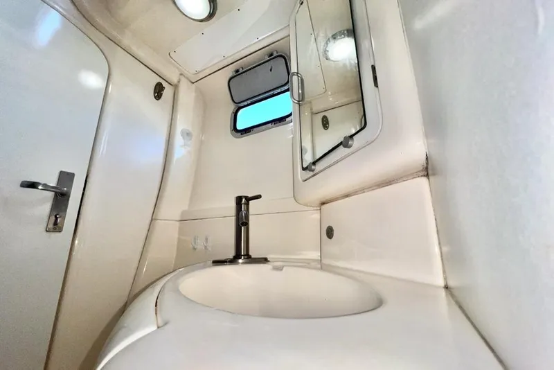 Slide: The Image of Compact bathroom interior of a 2000 Leopard 38 yacht, featuring a sink and mirror. - 71