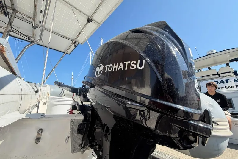 Slide: The Image of Tohatsu outboard motor on a Leopard 38 catamaran, 2000 model, under clear blue sky. - 93