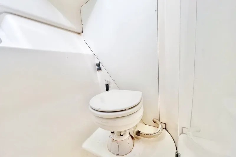 Slide: The Image of Compact marine toilet in a 2000 Leopard 38 catamaran bathroom. - 54