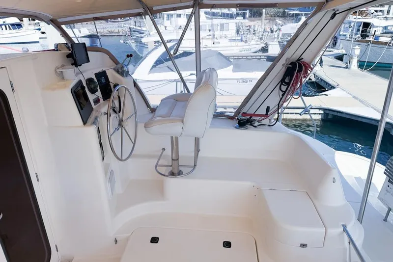 Slide: The Image of Interior view of a 2000 Leopard 38 yacht cockpit with steering wheel and seating. - 31