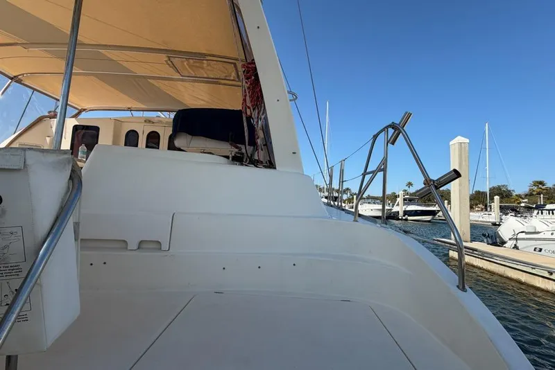 Slide: The Image of Leopard 38 catamaran, 2000 model, docked at marina under clear blue sky. - 150