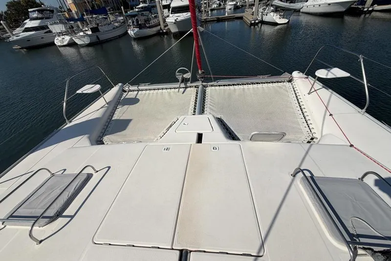Slide: The Image of Catamaran deck of 2000 Leopard 38, docked in marina with surrounding boats. - 121